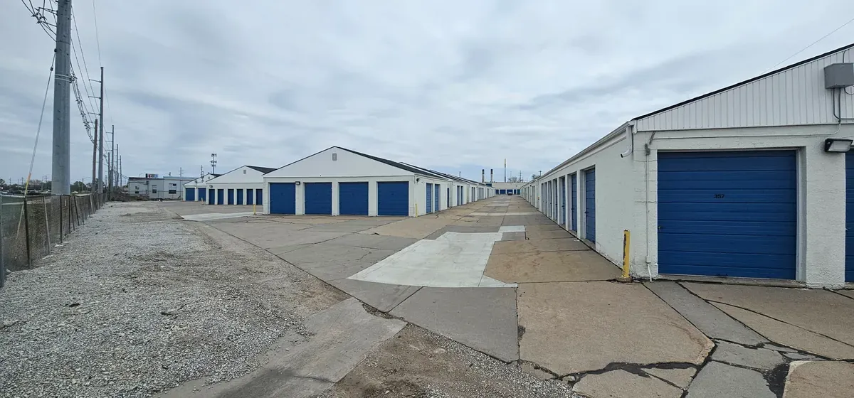 Wide driveway with drive up units and roll up doors.