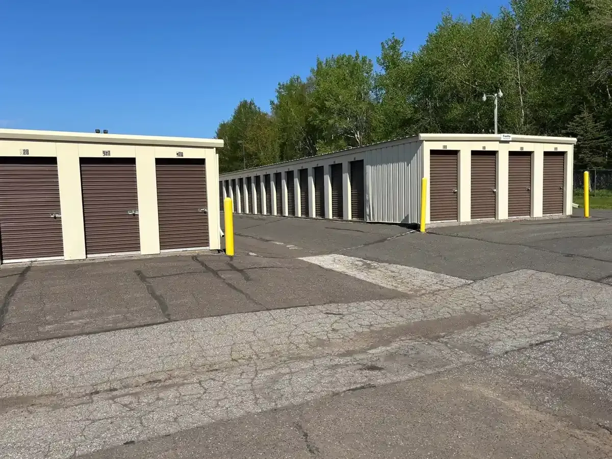 Wide driveway with drive up units and roll up doors.