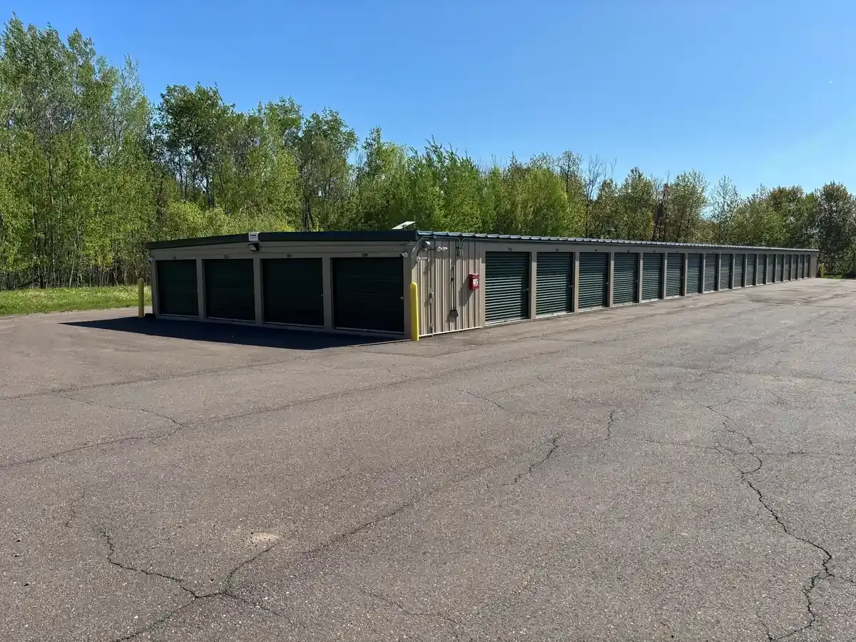Wide driveway with drive up units and roll up doors.