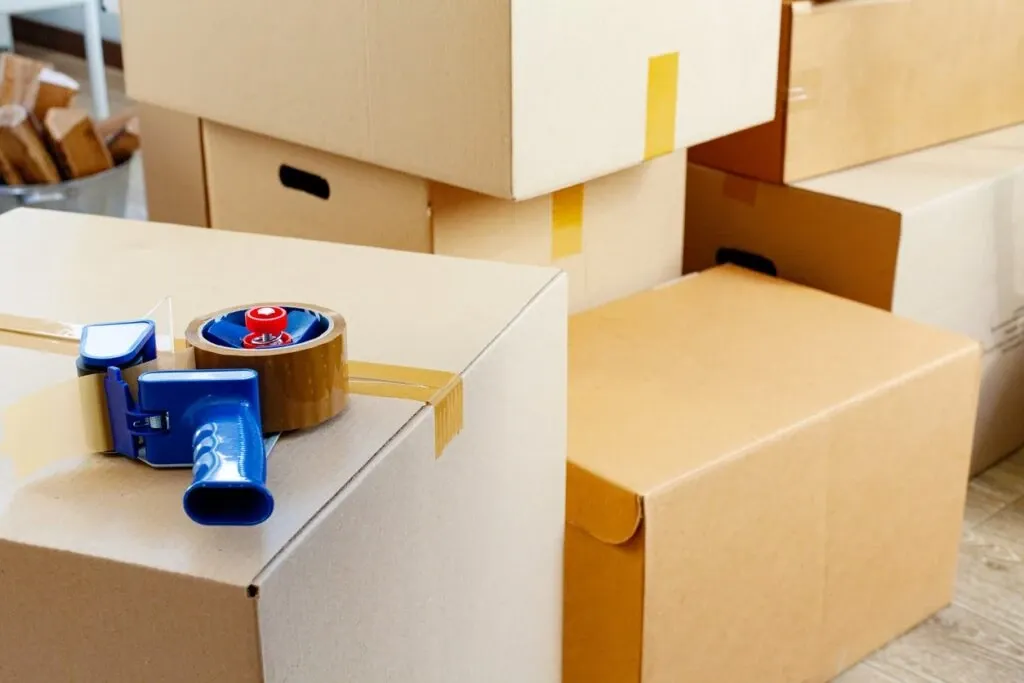 Packing supplies, including boxes and packing tape. 