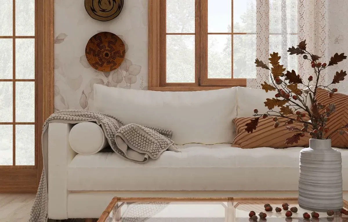 A sofa with light touches of fall accents throughout the room.
