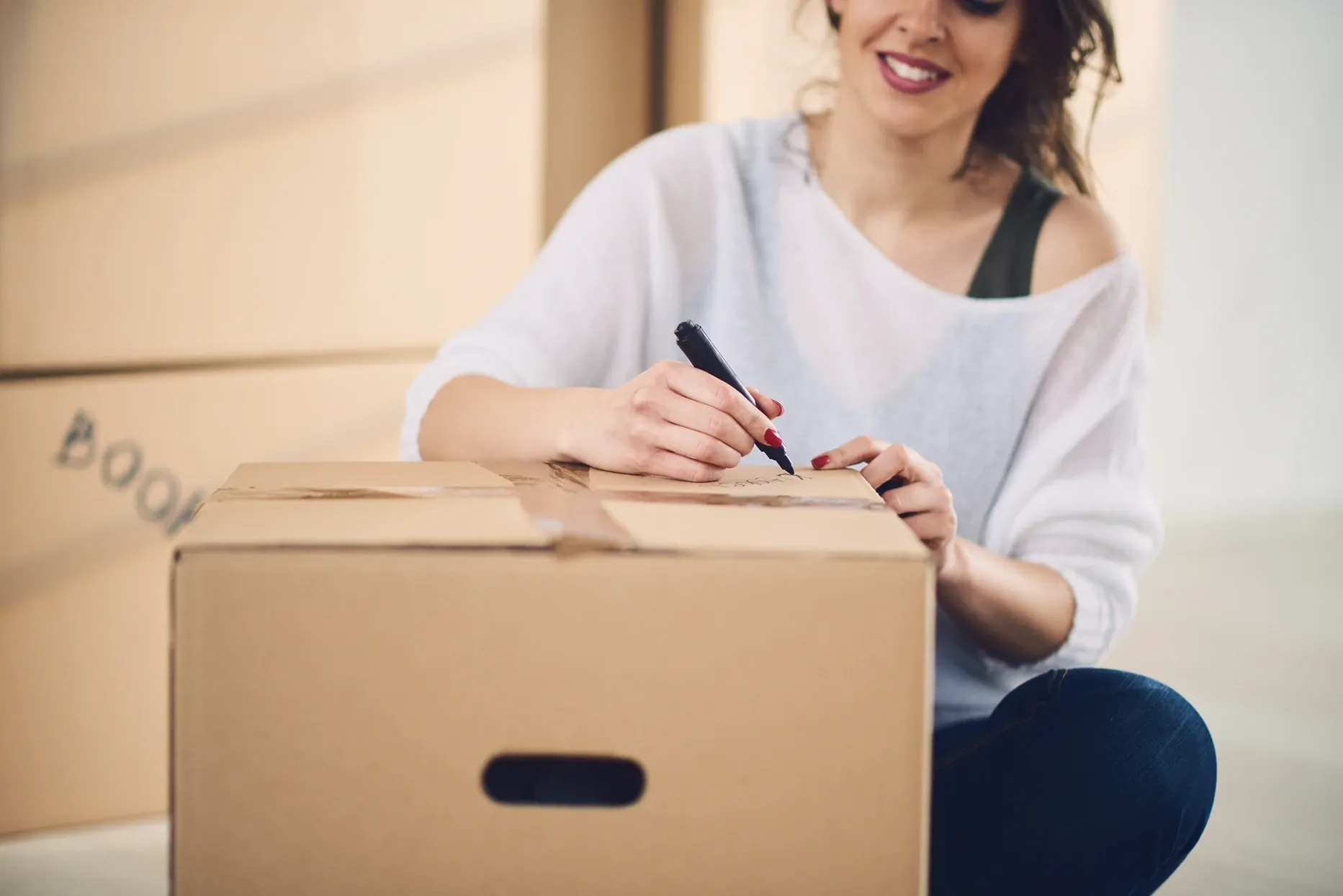 Woman labeling a moving box