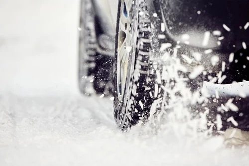 Close up of car tires in snow.