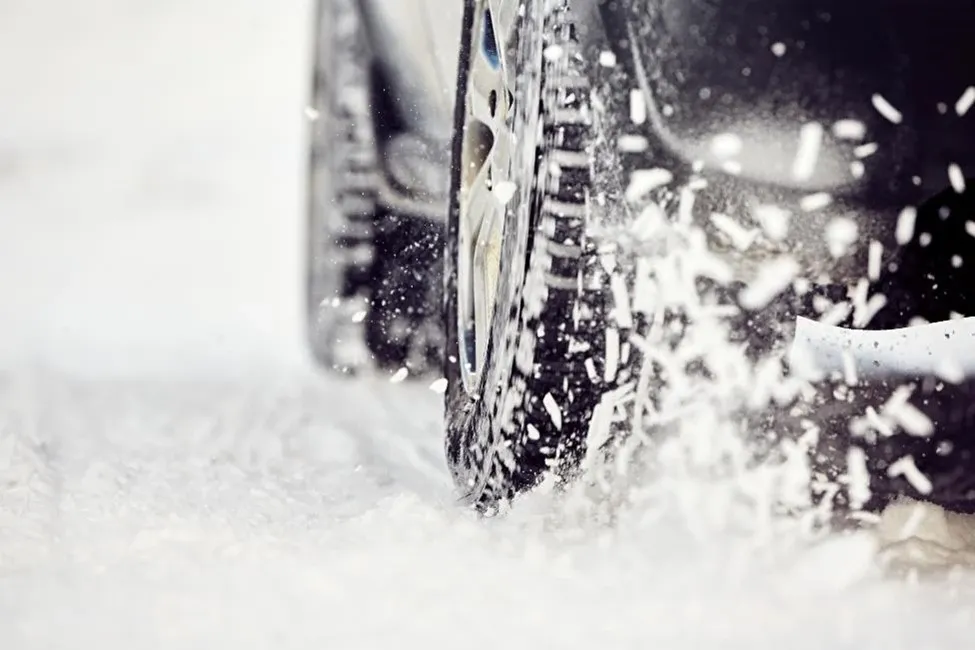 Close up of car tires in snow.