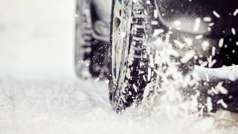 Close up of car tires in snow.