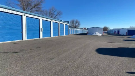 A row of outdoor, drive-up access storage units.