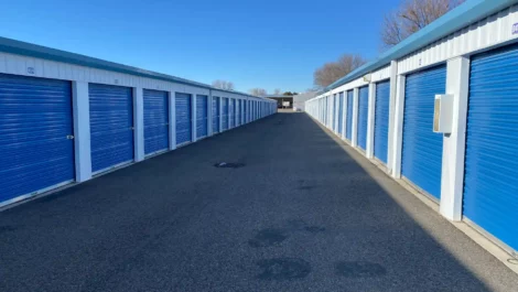 A row of outdoor, drive-up access storage units.