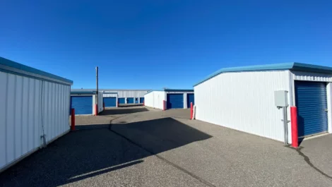 A row of outdoor, drive-up access storage units.