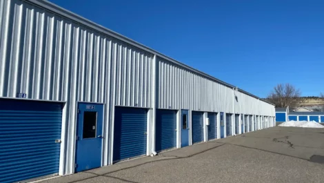 A row of outdoor, drive-up access storage units.