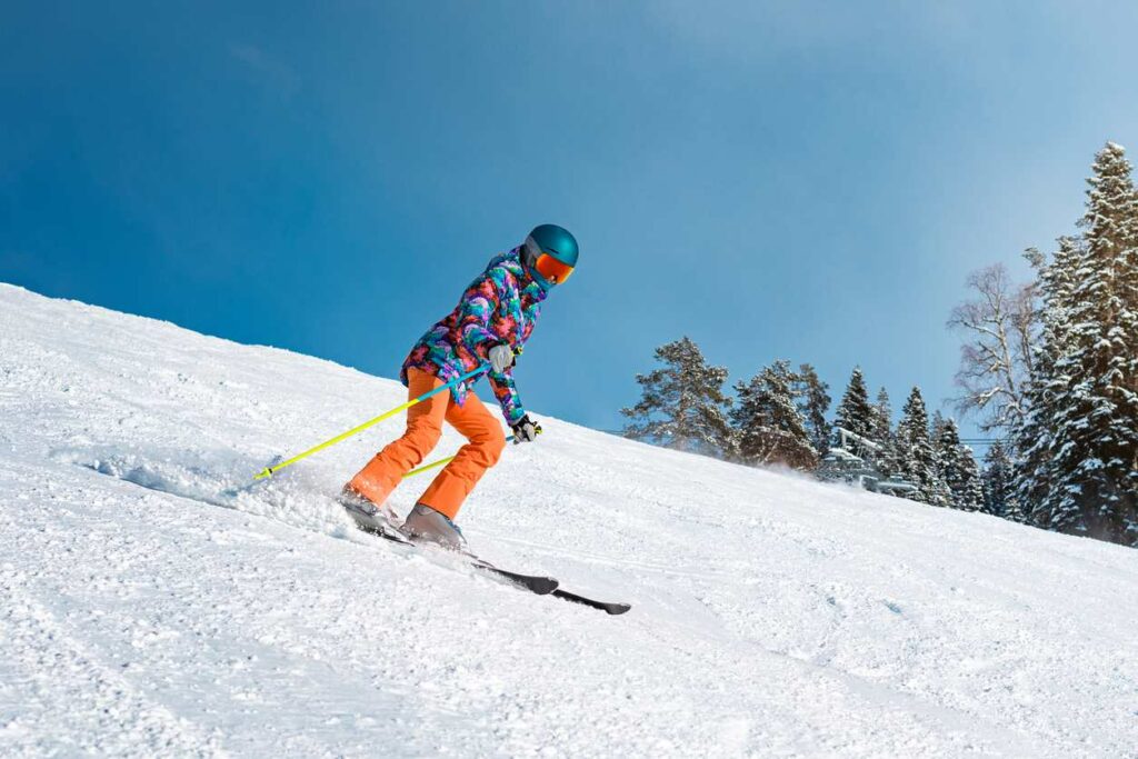 A skier going down a slope on a sunny day in South Dakota.