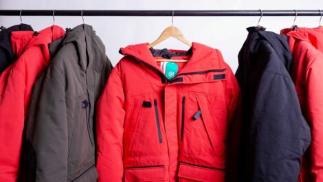 Winter coats and clothing hung up on hangers in the closet.