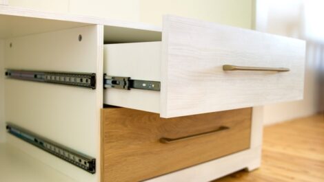 White and tan desk drawers with one open to fit a load of items.
