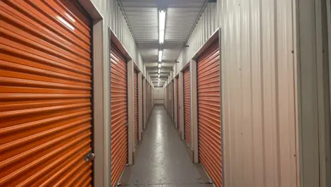 Close-up view of a row of individual storage unit doors inside the Five Star Storage facility in St. Paul, showing the numbered units and the locking mechanisms on each door.