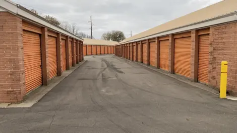 Exterior view of the loading area at the Five Star Storage facility on Marshall Avenue, St. Paul, featuring a covered area for easy loading and unloading, roll-up doors, and exterior lighting.